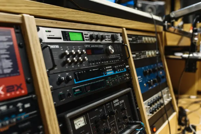 black audio mixer in brown wooden shelf